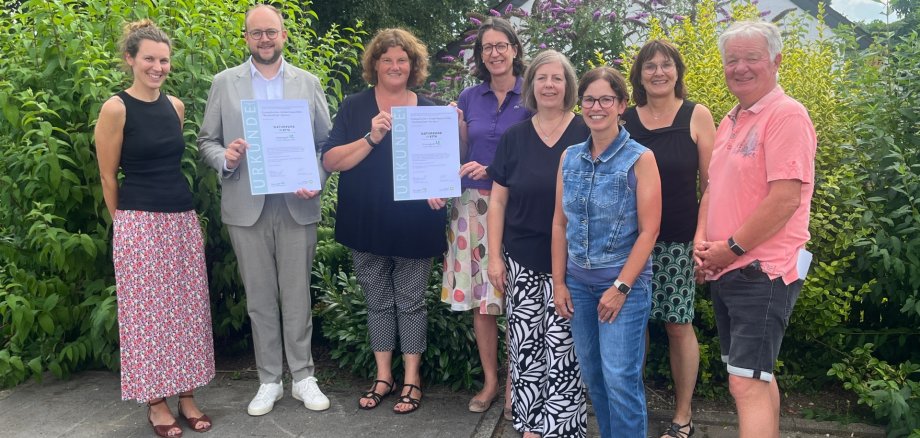 Übergabe der neuen Urkunde in der Naturpark-Kita „Waldwichtel“ in Hardert: Von links: Katrin Hoffmann (Naturpark Rhein-Westerwald), Verbandsgemeindebürgermeister Pierre Fischer, Kita-Leiterin Christine Fuhrmann, Fürstin zu Wied, 1. Vorsitzende des Naturparks Rhein-Westerwald, Daniela Anhäuser (Kita-Träger EWIKI), Michaela Neumann, Leiterin des Fachbereichs Kitas & Schulen, Geschäftsführerin Irmgard Schröer (Naturpark Rhein-Westerwald) und Gunter Jung, Ratsmitglied der Ortsgemeinde Hardert.