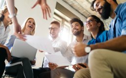 Startup business team on meeting in modern bright office interior brainstorming, working on computer