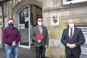 Foto: Landrat Achim Hallerbach (rechts) überreichte die Einbürgerungsurkunde an Abdulmunem Albatran. Als syrischer Flüchtling in den Landkreis Neuwieg gekommen, ist der Linzer dort und im gesamten Kreis bestens integriert. Zur Zeit absolviert er seine Ausbildung zum Verwaltungsfachangestellten in der Kreisverwaltung Neuwied. Mit auf dem Foto: Klaus Flesch (links) der die Einbürgerungen bei der Kreisverwaltung organisiert.