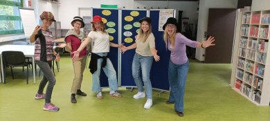 Auf dem Bild sind 5 Frauen zu sehen, die uns die Hände entgegenstrecken und Jede hat einen Hut auf dem Kopf.